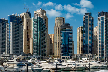 Fototapeta na wymiar blue, sky, white, clouds, Sunny, day, space, distance, panorama, city, houses, high-rises, skyscrapers, buildings, structures, concrete, glass, channel, emerald, water, reflections, pier, pier, yachts