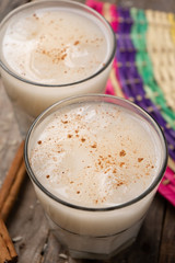 Mexican rice horchata with cinnamon on wooden background
