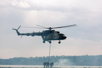 A military helicopter picks up a soldier