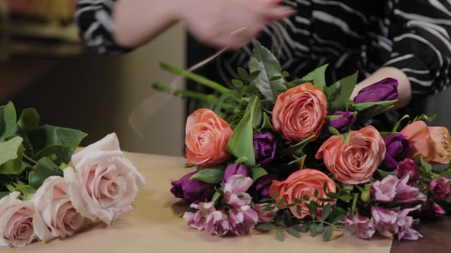 Professional florist collects a composition of flowers. Beautiful bouquet for International Women's Day.