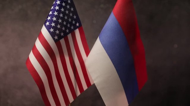 Closeup, flags on dark background. Concept of crisis of war and political conflicts between nations. Selective focus
