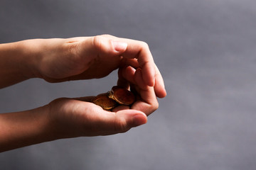 child hold in his little hands money euro on grey background