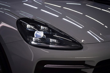 Obraz na płótnie Canvas New modern car headlights. Exterior detail.