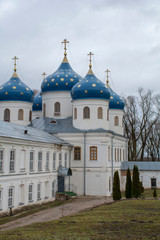 Fototapeta na wymiar View of Yuriev Monastery on a background of cloudy sky. Yuriev Monastery was founded in 1030 AD, Veliky Novgorod, Russia