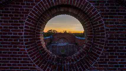 Sunset through the window of the destroyed church.