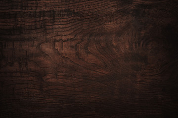 Dark brown wooden texture with beautiful structure. Wooden desk with vignette may used as background