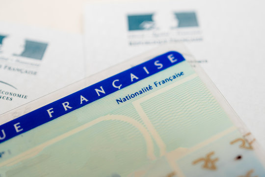 Paris, France - Mar 31, 2019: Tilt Shift lens close-up macro shot of National identity card Carte nationale d identite with focus on French nationality text