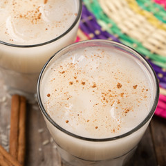 Mexican rice horchata with cinnamon on wooden background