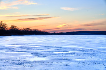 Scenic View of Orange Sunset over frozen Illinois Lake