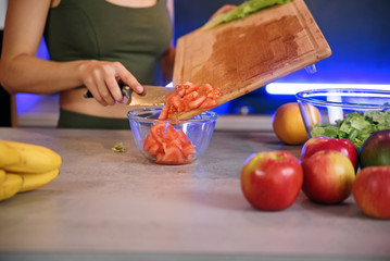 Woman hands cutting vegetables in the kitchen