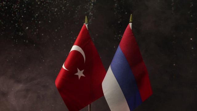 Closeup, flags on dark background. Concept of crisis of war and political conflicts between nations. Selective focus