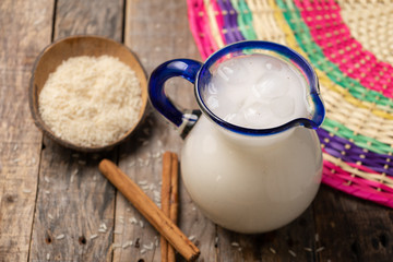 Mexican rice horchata with cinnamon on wooden background