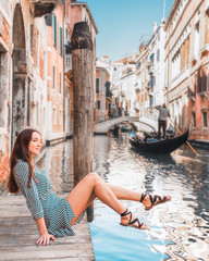 girl on the bridge of grand canal in venice italy