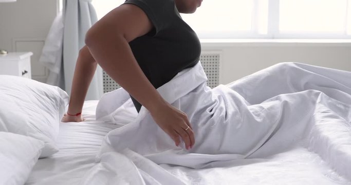 Sick african woman feel backache waking up in uncomfortable bed