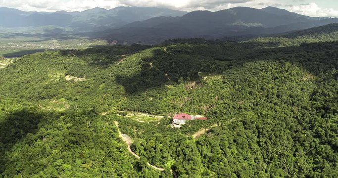 Fly over the rain forest of Rawang, Malaysia. Aerial view of the Malaysian landscape. a drone time lapse. small village north of Kuala Lumpur at the klang valley 