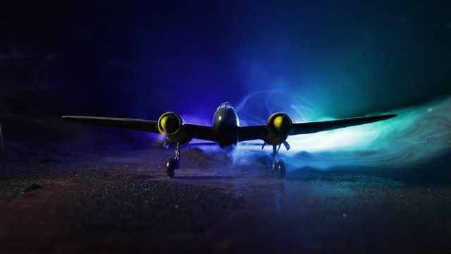 German Junker (Ju-88) night bomber at night. Artwork decoration with scale model of jet-propelled plane in possession. Toned foggy background with light. War scene. Selective focus