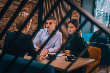Business meeting inside a cafe with the focus through a fence.