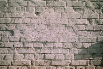 White brick wall witha shadow on a sunny day
