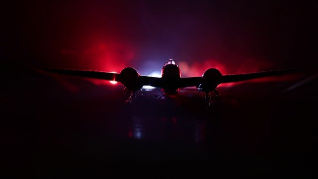 German Junker (Ju-88) night bomber at night. Artwork decoration with scale model of jet-propelled plane in possession. Toned foggy background with light. War scene. Selective focus