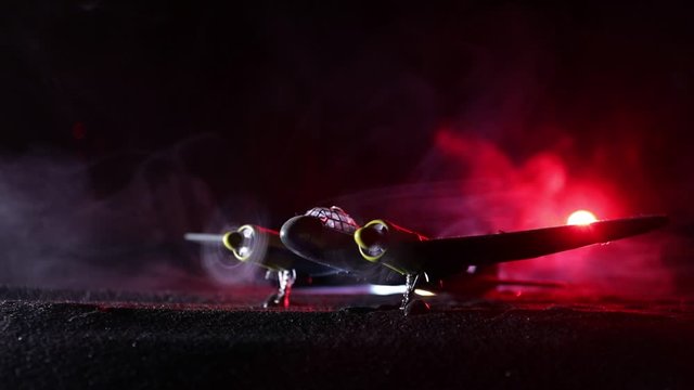 German Junker (Ju-88) night bomber at night. Artwork decoration with scale model of jet-propelled plane in possession. Toned foggy background with light. War scene. Selective focus