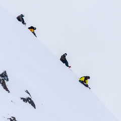 Group of snowboarders resting on the top of the mountain