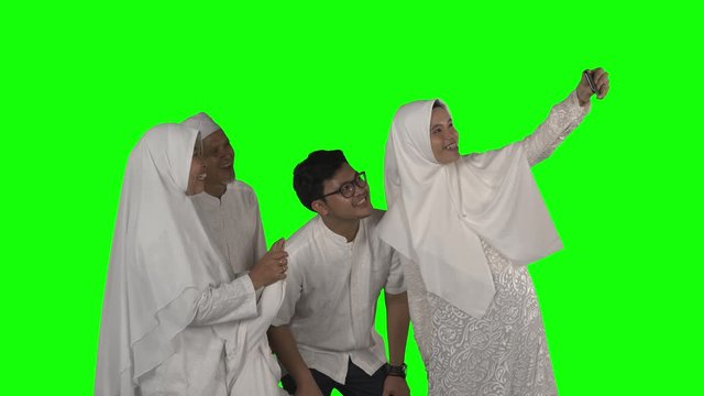 Three generation Muslim family take selfie on studio