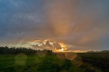 Obraz na płótnie Canvas scenic dramatic sunset sky background over a field in the region 