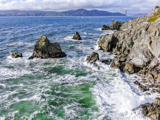 Drone view of waves hitting the rocks at Lands End, San Francisco