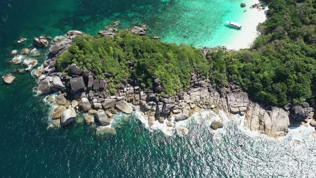Footage B-roll of Aerial view ocean waves, beach and rocky coastline and beautiful forest. Nyaung Oo Phee Island Myanmar Tropical seas and islands in southern Myanmar. Beautiful tourist attractions.