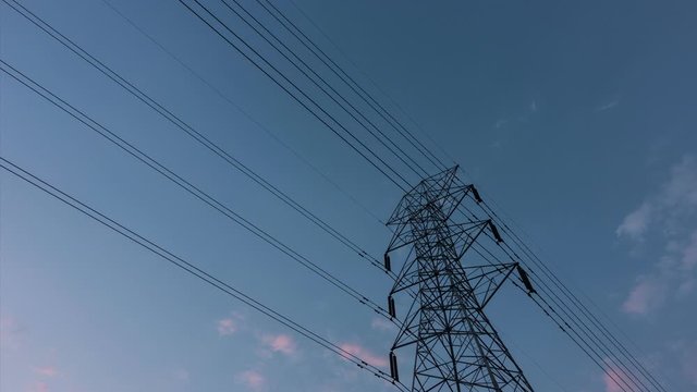 Footage B roll 4K TimeLapse of high voltage post. High-voltage tower sky background. electric pole with blue sky and clouds with sunset. Time lapse footage video. World energy concept.