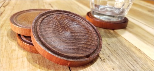 jar of honeyWooden coasters made from rubber,wood, with glass of water,on the surface of wood background,