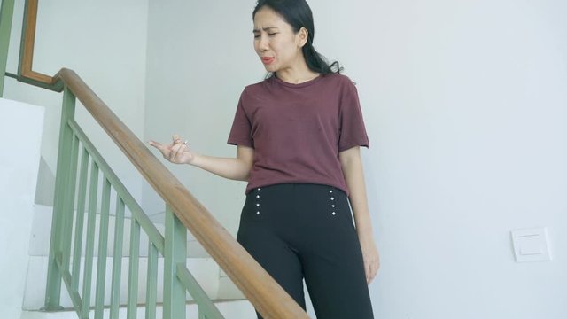 Woman looks disgusted after touched dirty banister