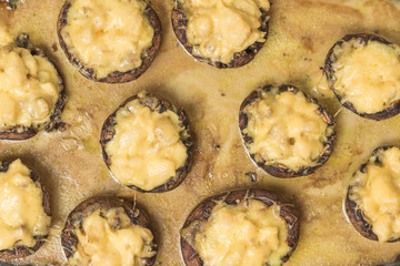Background of baked mushrooms with chicken and cheese.