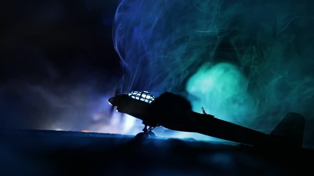 German Junker (Ju-88) night bomber at night. Artwork decoration with scale model of jet-propelled plane in possession. Toned foggy background with light. War scene. Selective focus