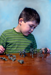 boy with plastic toy soldiers