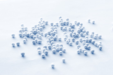 Romantic pattern of blue and blue beads scattered on a soft blue background, festive pattern for...