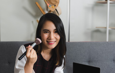 Beautiful Asian blogger woman review and demonstrate about cosmetic stylish while online live...
