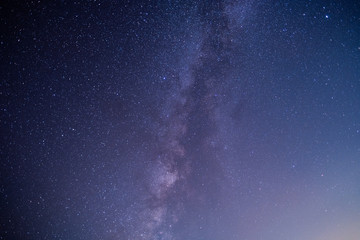 The stars and the milky way in the dark sky at night are very beautiful.