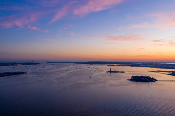 New York City with Ellis Island and Statue of Liberty in sunset, aerial photography 