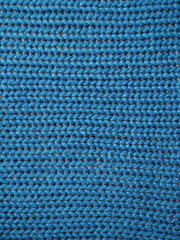 Blue knitted textured background, knit with facial loops.