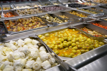 variety of colorful fresh vegetable salad in container in restaurant