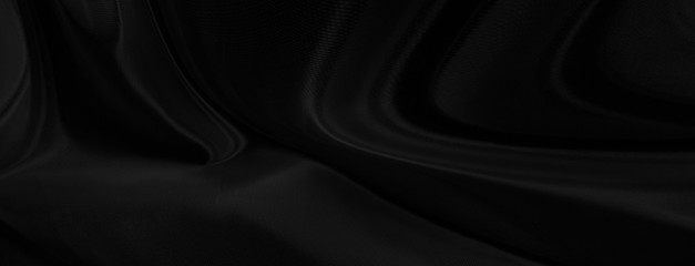 Black gray satin dark fabric texture luxurious shiny that is abstract silk cloth panorama...