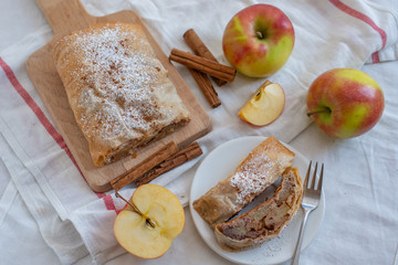 Healthy Home made sweet Apple strudel with apples, cinnamon on a table