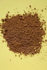guarana powder  on a light yellow background.Super food. Useful product. Healthy eating concept. Natural energetic. Portion of Guarana Powder.Pile of guarana powder. copy space.