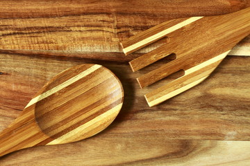 wooden fork and spoon on wooden board for background. healthy habits shot note background concept