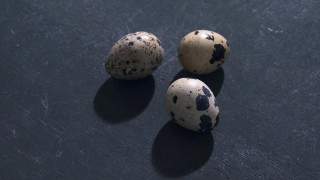 raw quail eggs on gray background