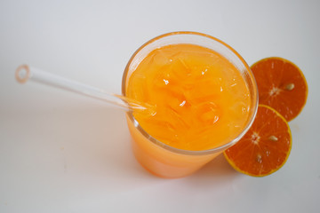Orange juice in glass and orange fruit on white background, Zoom macro.