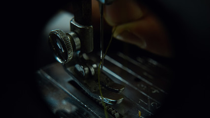 Thread a Needle on a Sewing Machine Close-up. Tailor Concept.