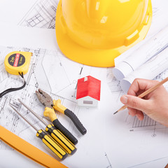 Yellow hard hat tools and drawings