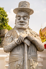 Chinese dolls dressed in western style stone statues At Wat Pho or Phra Chetuphon Wimon Mangkararam Temple an ancient temple in Bangkok, Thailand